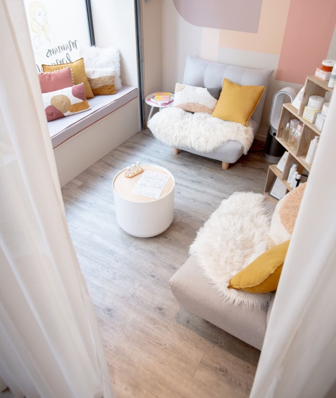 Photo de l'espace d'accueil du salon du 8ème avec fauteuils et coussins